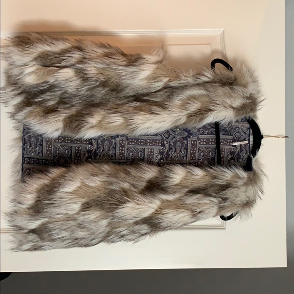 Faux fur free people vest with paisley lining.